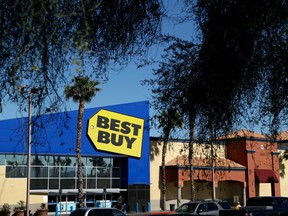 FILE - In this May 23, 2017, photo, cars are parked in front of a Best Buy in Las Vegas. The online powerhouse, Amazon, announced Wednesday, April 18, 2018, that it's teaming with consumer electronics retailer Best Buy on new Fire TV Edition smart tvs.