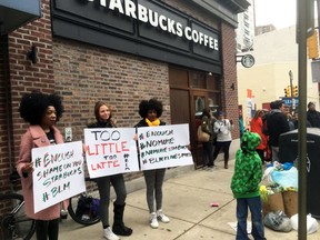 Protesters gather outside a Starbucks in Philadelphia, Sunday, April 15, 2018, where two black men were arrested Thursday after Starbucks employees called police to say the men were trespassing. The arrest prompted accusations of racism on social media. Starbucks CEO Kevin Johnson posted a lengthy statement Saturday night, calling the situation "disheartening" and that it led to a "reprehensible" outcome.