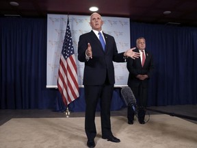 U.S. Vice President Mike Pence speaks during a press conference at the Summit of the Americas in Lima, Peru, Saturday, April 14, 2018. Behind is Acting U.S. Secretary of State John Sullivan.