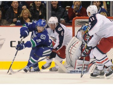 Jan 5, 2010 -- Daniel Sedin is chased around the net by Columbus Blue Jackets Jan Hejda (6) during first period NHL regular season action at GM Place