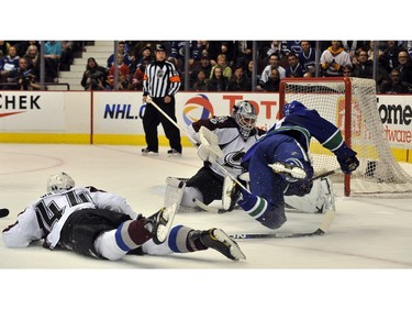 March 16, 2011 -  Daniel Sedin, #22 (R) is tripped by Ryan WEilson, #44(L) of the Colorado Avalanche in front of goalie Brian Elliott, #30(C) during third period NHL action at Rogers Arena.