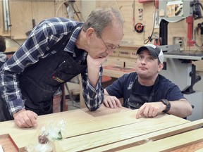 Volunteer Jerry Hurn, left, talks over a project with Martin Granger at the Tetra woodworking shop, a 620-square-foot, fully accessible shop in the sub-basement of Vancouver's Blusson Spinal Cord Centre.