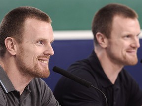 Daniel (l) and Henrik Sedin talks to media as they wrap up their season with a final press conference in West Vancouver, BC., April 9, 2018.