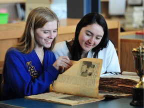 VANCOUVER, BC., April 18, 2018 -- Theresa Cotton (l) and Sam Kerr  look at archival material as Kitsilano High School celebrates its centennial this May, in Vancouver, BC., April 18, 2018.  (NICK PROCAYLO/PostMedia)   00053021B ORG XMIT: 00053021B [PNG Merlin Archive]