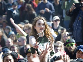 Revellers  hand out free joints as hundreds took part in the annual "4/20 celebration" and smoke up in front of Sunset beach in Vancouver on  April 20, 2017.