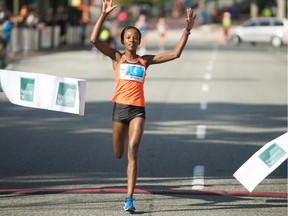 Monicah Ngige is the first female runner to cross the finish line at The Vancouver Sun Run on April 22.