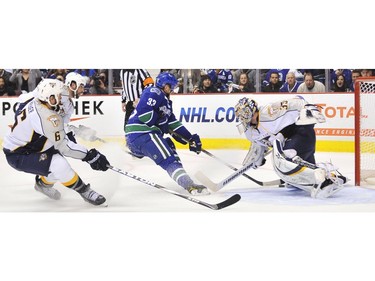 APRIL 28: Nashville Predators Shea Weber (left) and David Legwand ( second left) chase Vancouver Canucks Henrik Sedin (centre) as he drives the puck to Nashville Predators goalie Pekka Rinne (right )in the third period of Game One of the Western Conference Semifinals.