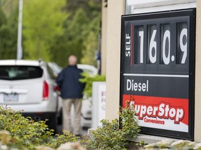 A motorist fills up his car at 160.9 a litre, the posted price for regular gas in Surrey, BC, April, 30, 2018.