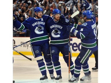 may 7, 2010: Sedin twins celebrate goal by Daniel (right) with Alex Burrows  against Chicago Blackhawks  in game four of NHL playoffs.