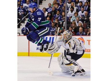 MAY 7, 2011: Vancouver Canucks Daniel Sedin (left) leaps in front of Nashville Predators goalie Pekka Rinne (right) during the third period of game five in the NHL 2011 Stanley Cup Championship Western Conference semi final at Rogers Arena.
