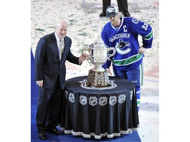 MAY 24, 2011 - Vancouver Canucks Captain Henrik Sedin (R)is careful not to touch it as he poses with the Clarence S. Campbell cup along with deputy commisioner Bill Dailey (L) after their overtime victory over the San Jose Sharks in the second overtime period of Game Five of the Western Conference Finals.