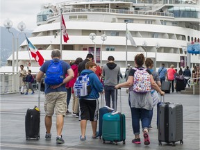 Cruise ship passengers makes their way to the cruise ship terminal at Canada Place in Vancouver, B.C., August, 14, 2017.
