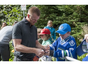 WHISTLER,BC:  Sept. 19, 2013 -- Daniel Sedin sign autographs after the first session of the 2014 Vancouver Canucks Training Camp in Whistler.