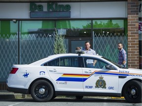A Surrey RCMP car is parked outside Da Kine marijuana shop in 2016. Today, the city is working on where and how to allow pot shops when cannabis is legalized.