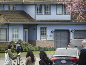 News crews gather outside a home in Surrey that was the scene of a fatal fire earlier this week. The home was being used to legally grow medical marijuana.