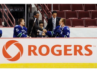 Oct. 8,  2010: Victor de Bonis, right, the COO and Alternate Governor of  Canuck Sports and Entertainment and Nadir Mohamed, left, President and CEO, Rogers Communications, meet Daniel, left, and Henrik Sedin as the team formally announces the deal that gives the media company naming rights to Rogers Arena.