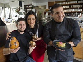 Chef Jefferson Alvarez, right, holds his special halibut ceviche dish with team member Matthew Gayowski, left, and partner Marcela Ramirez at Cacao Restaurant at 1st and Cypress in Vancouver.