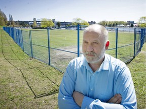 Longtime 4/20 organizer Dana Larsen outside of the heavy fencing around the grass in Sunset Beach Park, where city crews are presently working on repairing the grass after last Friday's 4/20 rally.