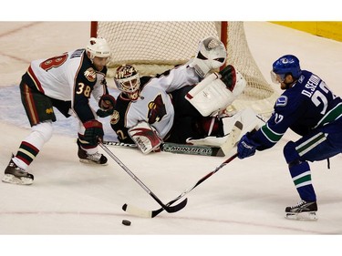 Jan. 21, 2008: Daniel battles for the puck with  Minnesota Wild Pavol Demitra (38) in front of goalie Niklas Backstrom (32) during the second period.