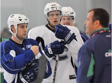 Sept. 21 2008: Canucks (M) Alexander Edler listens to coach Alain Vigneault with Kyle Wellwood and Daniel Sedin during training camp at Meadow Park Sports Centre in Whistler.