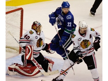 Nov. 25, 2007: Daniel Sedin (22) jumps in front of Chicago Blackhawks goalie Patrick Lalime (40) and behind Brent Sopel (5) during the third period.