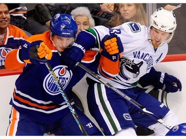 Nov. 28, 2009 - Henrik Sedin (33) collides with Edmonton Oilers'   Ladislav Smid (5) during first period.