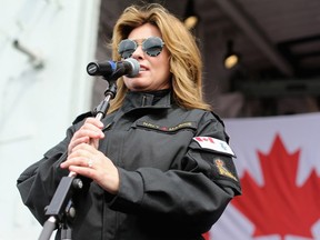 Canadian music star Shania Twain addresses the crowd on the flight deck of HMCS Ottawa at CFB Esquimalt on Thursday, April 19, 2018.