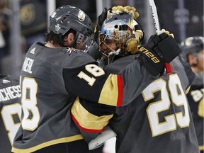 Vegas Golden Knights goaltender Marc-Andre Fleury (29) celebrates with left wing James Neal after the Golden Knights defeated the San Jose Sharks 7-0 in Game 1 of an NHL hockey second-round playoff series Thursday, April 26, 2018, in Las Vegas.