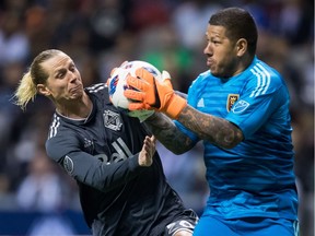 Real Salt Lake goalkeeper Nick Rimando, right, makes a save as Brek Shea of the Whitecaps looks for a rebound during the second half of Friday's MLS game at B.C. Place Stadium in Vancouver.