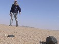 Astronomer Peter Jenniskens finds a fragment of the Almahata Sitta meteorite, which contains diamonds, on Feb. 28, 2009, in the Nubian desert of Sudan.