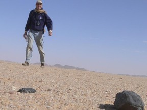 Astronomer Peter Jenniskens finds a fragment of the Almahata Sitta meteorite, which contains diamonds, on Feb. 28, 2009, in the Nubian desert of Sudan.