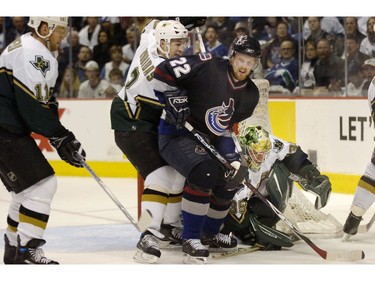 April 11, 2007: Vancouver Canucks  Daniel Sedin 22 tries to steer around Dallas's Stepane Robidas and goalie Marty Turco.