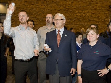Oct. 14, 2009 -- Henrik Sedin and BC Premier Gordon Campbell play Wii basketball while BC Special Olympian Cheryl Spurr looks on during the Sports Celebrities Festival in support of the Canucks for Kids Fund and the BC Special Olympics in Vancouver.