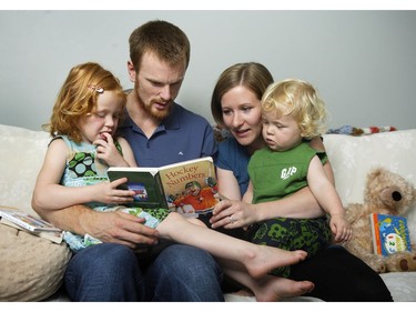 Sept. 20, 2009:  (L middle) Daniel and(R middle) Marinette Sedin and their two children, (far L) Rona and (far R) Eric, at home, reading. For Raise a Reader series.