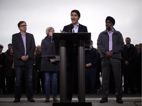 Prime Minister Justin Trudeau speaks to media as he's joined by Defence Minister Harjit Sajjan, right, Minister of Public Services Carla Qualtrough and MP Jonathan Wilkinson after meeting with Canadian Coast Guard workers to discuss marine safety and spill prevention, in Victoria on Thursday, April 5, 2018.