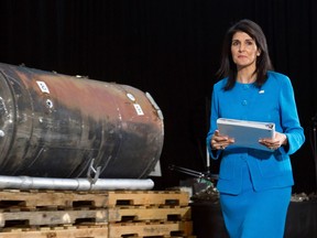 In this Dec. 14, 2017, file photo, U.S. Ambassador to the UN Nikki Haley walks past recovered remains of an Iranian rocket during a press briefing at Joint Base Anacostia-Bolling in Washington.