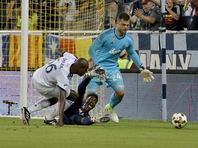 Vancouver Whitecaps midfielder Ali Ghazal tackles Sporting Kansas City forward Gerso at the six-yard box during the first half of last season's match at Children's Mercy Park. The two sides meet again Friday in K.C.