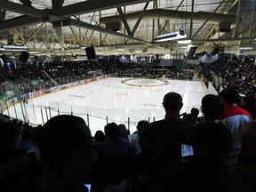 People listen to speakers during a vigil at the Elgar Petersen Arena, home of the Humboldt Broncos, to honour the victims of a fatal bus accident, April 8, 2018 in Humboldt, Canada. Mourners in the tiny Canadian town of Humboldt, still struggling to make sense of a devastating tragedy, prepared Sunday for a prayer vigil to honor the victims of the truck-bus crash that killed 15 of their own and shook North American ice hockey.