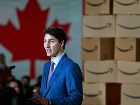 Prime Minister Justin Trudeau is surrounded by Amazon employees as he announces Amazon will be creating 3,000 jobs during a press conference April 30, 2018 in Vancouver, British Columbia.