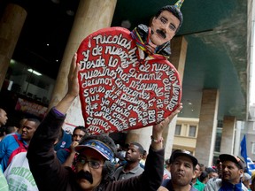 A supporter of Venezuela's President Nicolas Maduro stands outside the government-controlled National Electoral Council in Caracas, Venezuela, Tuesday, May 22, 2018. Countries around the world slammed its “fraudulent” election over the weekend that returned Maduro to power.