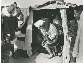 July 1970: Queen Elizabeth during her visit to Resolute Bay, an Inuit hamlet on Cornwallis Island in what was then the Northwest Territories and is now Nunavut. Here she is visiting a reconstruction of an old-style sod hut.