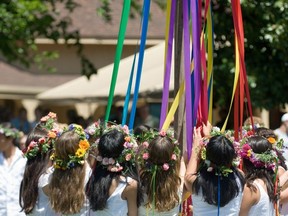 Children dance around the May Pole.