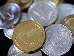 In this photo illustration of the litecoin, ripple and ethereum cryptocurrency 'altcoins' sit arranged for a photograph on April 25, 2018 in London, England.