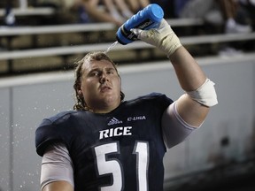 Offensive lineman Peter Godber of the Rice University Owls cools off on the bench during an NCAA football game on Sept. 23, 2017 at Rice Stadium in Houston, Texas.