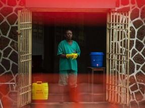 An attendant charged to handle the access to the Ebola security zone stands at the entrance of the Wangata Reference Hospital in Mbandaka on May 20, 2018. Three new Ebola cases have been confirmed in the Democratic Republic of Congo's sprawling northwest taking the number of suspected infections to 43, the health minister said in a statement seen on May 19, 2018.