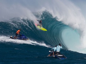 Paige Alms surfs a big wave at Jaws, off the coast of Maui during the Peahi Challenge 2016, the first Women's Big Wave Tour event.