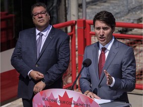Prime Minister Justin Trudeau, right, speaks during an infrastructure announcement as Calgary Mayor Naheed Nenshi looks on in Calgary, Alta., Tuesday, May 15, 2018.