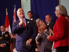 John Horgan gives a thumbs up after giving an oath with Lieutenant-Governor Judith Guichon as he's sworn-in as Premier during a ceremony with his provincial cabinet at Government House in Victoria on July 18, 2017.