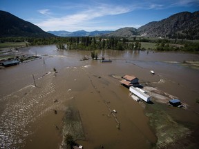 A home damaged by flood waters is seen in an aerial view, near the Kettle River in Grand Forks, B.C., on Saturday May 12, 2018. Thousands of people have been evacuated from their homes in British Columbia's southern interior as officials warn of flooding due to extremely heavy snowpacks, sudden downpours and unseasonably warm temperatures.