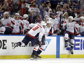 Washington Capitals, including Alex Ovechkin (8) celebrate after defeating the Tampa Bay Lightning in Game 7 of the NHL Eastern Conference finals hockey playoff series.